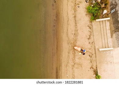 A top down shot taken directly over a woman who was preparing to take out her kayak. It is a cloudy morning on the shore of the Hudson River in upstate New York. - Powered by Shutterstock