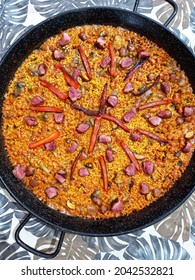 Top down Valencian paella with peppers and duck perfectly cooked