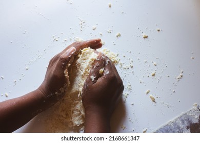 Top Down View Of An African American Woman Kneading Pie Dough On A White Work Bench