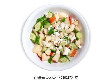 Top Down View Of An Apple And Cucumber Salad In A White Bowl Isolated On A White Background. Contains Clipping Path Around The Bowl.