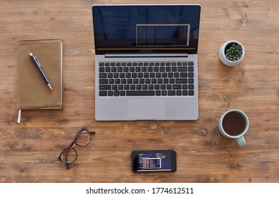 Top Down View Background Composition Of Laptop And Smartphone With Computer Code On Textured Wooden Desk In Office, Copy Space