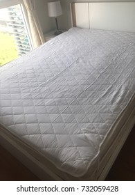 A Top Down View Of A Bed Unmade Up White Bed.