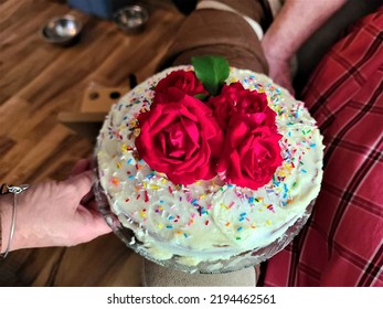 A Top Down View Of A Birthday Cake With Roses Placed On Top Of It.