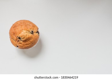 Top Down View Of A Blueberry Muffin Against White Background With Copy Space.