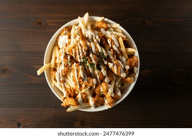 A top down view of a bowl of chicken shawarma fries.