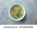 A top down view of a bowl of miso soup.