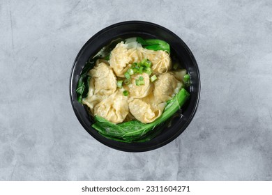 A top down view of a bowl of wonton soup. - Shutterstock ID 2311604271