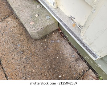 A Top Down View Of Broken Glasses Left On A Sidewalk.