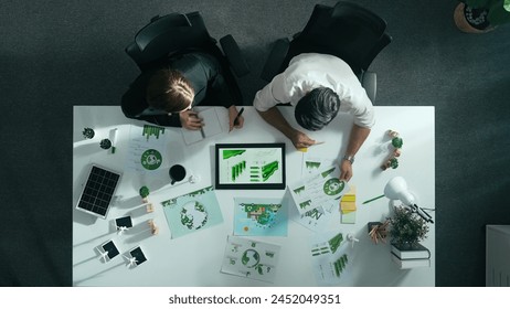 Top down view of business man presenting sustainable idea to manager by using tablet display ESG environmental social governance. Manager working together planning to use clean energy. Alimentation. - Powered by Shutterstock