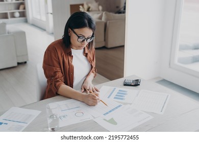 Top Down View Of Businesswoman Examining Reports A The Desk At Home. Young Hispanic Woman In Glasses Is Working At Home Office On Quarantine. Business Assistant, Freelancer Is Working On Project.