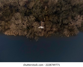 Top down view of a cabin on the shore of a river