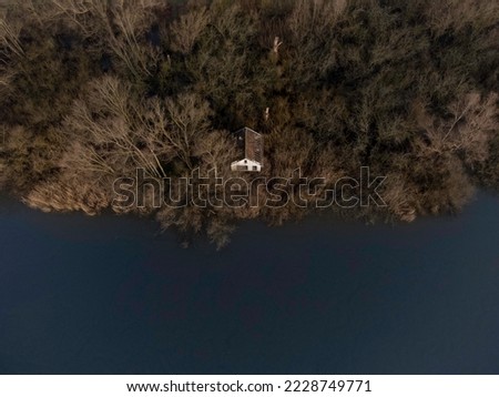 Top down view of a cabin on the shore of a river