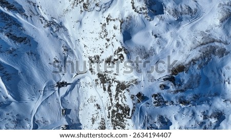 Top down view cable car station, restaurant and piste in winter in Schwarzsee. Aerial drone view in snowy natural landscape with skiers. Ski areal Zermatt in Swiss.