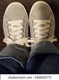 Top Down View Of Canvas Tennis Shoes With Rolled Up Jeans