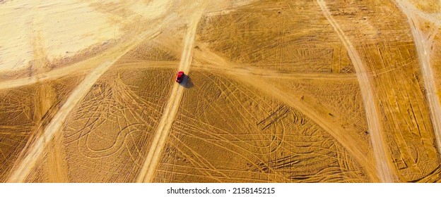 Top Down View Of A Car Passing Through Desert.