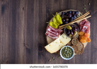 A Top Down View Of A Charcuterie Board Filled With Various Healthy Finger Foods.