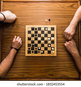 Top Down View Of Chess Game On A Wooden Table