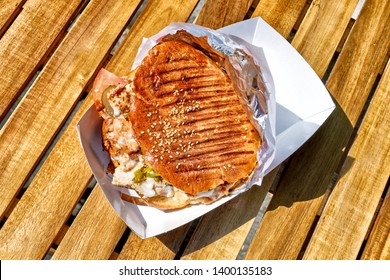 Top Down View Of Chicken Doner Kebab Sandwich In Natural Light On Open Air Restaurant Wooden Table Background Turkish Middle East Arabian National Food Concept Plain Overview Of Fast Food Meal