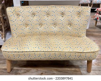 The Top Down View Of A Child Sized Sofa With A Yellow And Blue Floral Design.