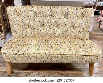 The Top Down View Of A Child Sized Sofa With A Yellow And Blue Floral Design.