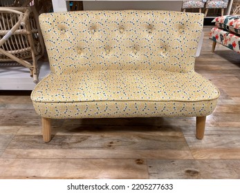 The Top Down View Of A Child Sized Sofa With A Yellow And Blue Floral Design.