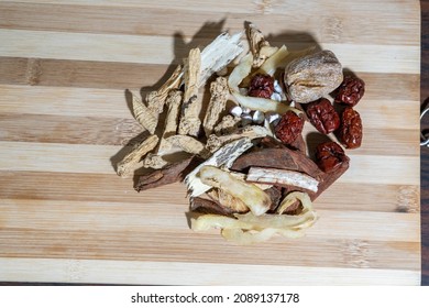 Top Down View Of Chinese Herbs For Soup Making On A Wooden Board In Portrait View