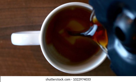 Top Down View Of Coffee Being Poured In A Cup