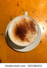 Top Down View Of Coffee Cup And Saucer On Wooden Table, Cappuccino 