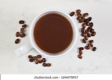 Top Down View Of Coffee Cup And Fresh Coffee Beans.