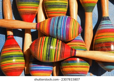 Top down view of colorful percussion maraca instruments from dried Mexican gourds on display
