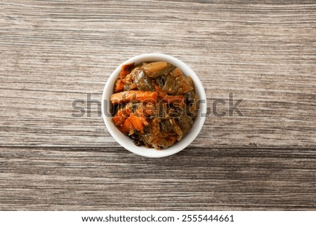 A top down view of a condiment cup of fossolia.