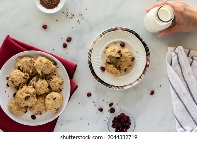 Top Down View Of Cranberry Flax Breakfast Cookies With A Bottle Of Milk, Ready For Snacking.