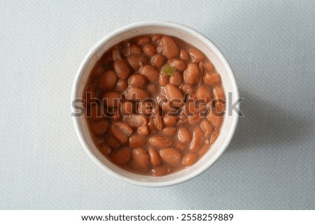 A top down view of a cup of pinto beans.