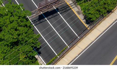 A Top Down View Directly Above A Quiet Highway On A Sunny Day With Green Trees And Grass In View. Taken By A Drone Camera Showing The Beautiful Long Island Landscape.