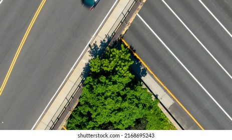 A Top Down View Directly Above A Quiet Highway On A Sunny Day With Green Trees And Grass In View. Taken By A Drone Camera Showing The Beautiful Long Island Landscape.