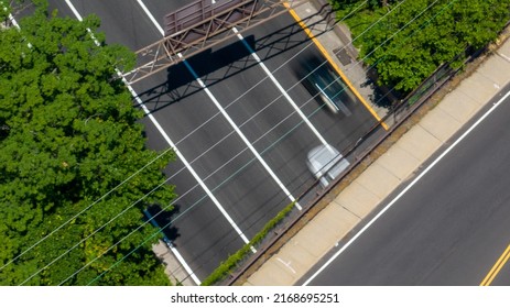 A Top Down View Directly Above A Quiet Highway On A Sunny Day With Green Trees And Grass In View. Taken By A Drone Camera Showing The Beautiful Long Island Landscape.