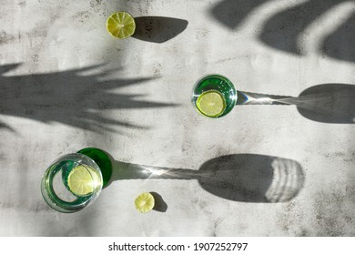 Top Down View Of Drinks And Shadows With Lime, Tropical Mood On Light Surface