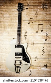 Top Down View Of Electric Guitar With Note Melody On The Wooden Table