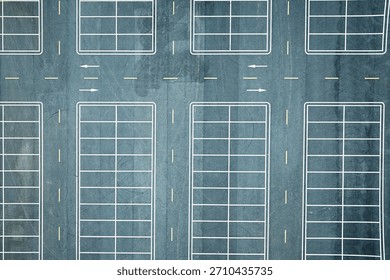 Top down view of empty parking lot with white lines on blue asphalt ground background.