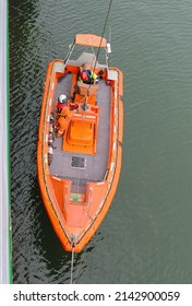 Top down view, Fast Rescue Boat (FRC) lowered and prepared for launching from a ship. FRC is used in search and rescue missions and man overboard situations. - Shutterstock ID 2142900059