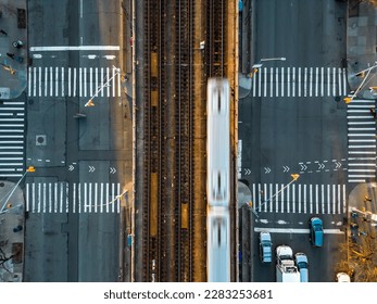 A top down view of the Flushing Line of the New York City Subway train tracks that run down the center of Queens Boulevard. Taken during sunset.