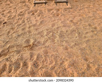 A Top Down View Of Footprints In A Sand Box.