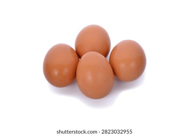 A top down view of four raw brown chicken eggs isolated on a white background suitable for food preparation concepts