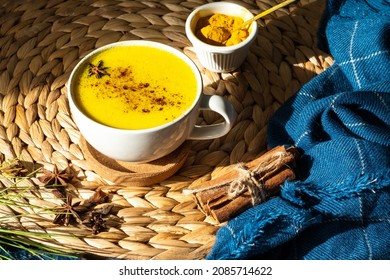 Top Down View Of Golden Milk Or Turmeric Latte Cup On A Straw Plate Stand.