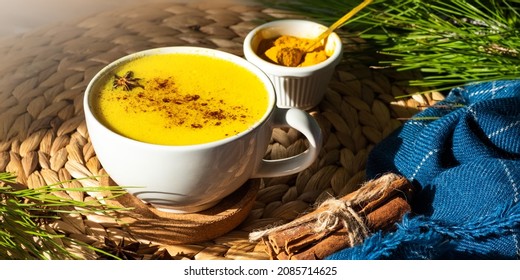 Top Down View Of Golden Milk Or Turmeric Latte Cup On A Straw Plate Stand.