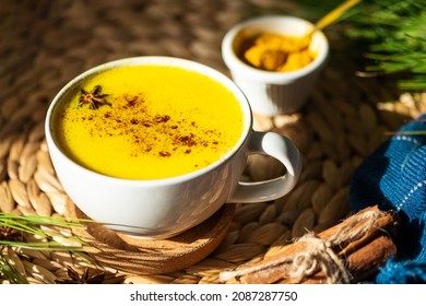 Top Down View Of Golden Milk Or Turmeric Latte Cup On A Straw Plate Stand.