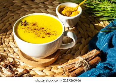 Top Down View Of Golden Milk Or Turmeric Latte Cup On A Straw Plate Stand.