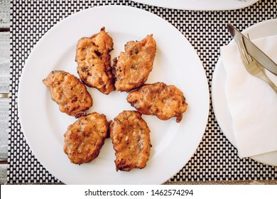 Top Down View Of Greek Food: Santorini Tomato Balls ( Tomato Fritters, Tomatokeftedes) In Greece, Santorini Island Tavern Table.