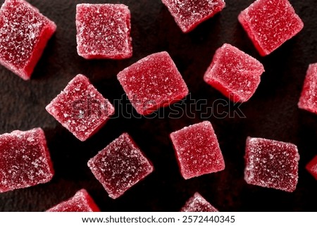 A top down view of a layer of edible red sour candy.