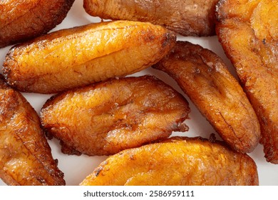 A top down view of a layer of fried plantains, as a background.